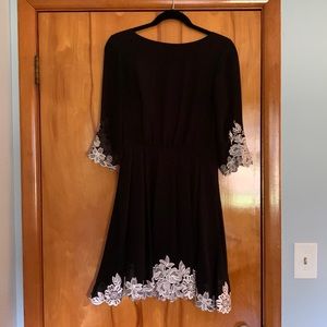Ted Baker black dress with 3/4 sleeves and white embroider around the hems.